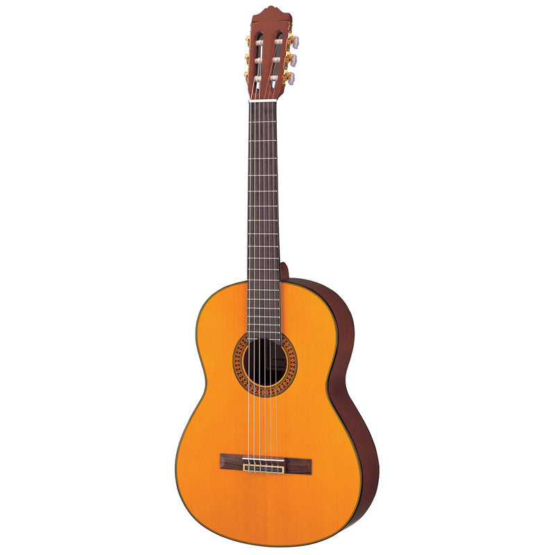 Yamaha C80 full-size nylon-string classical guitar in gloss natural, front view showing the spruce top, decorative rosette, rosewood bridge, nato sides and slotted headstock with gold tuners