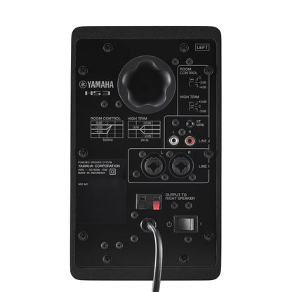 Rear panel of the black Yamaha HS3 left speaker, showing the Room Control and High Trim switches, stereo mini and RCA LINE 2 inputs, combo XLR/TRS LINE 1 inputs and the output terminals to the right speaker