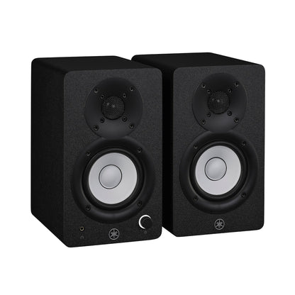 Yamaha HS3 powered studio monitors in black, angled pair view, with white cones and the left speaker's front volume knob and headphone jack