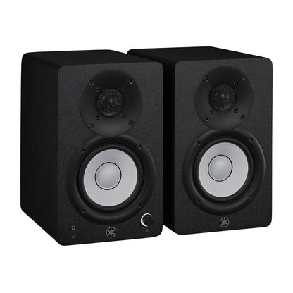 Yamaha HS4 powered studio monitors in black, angled pair view with Yamaha's white cone woofers