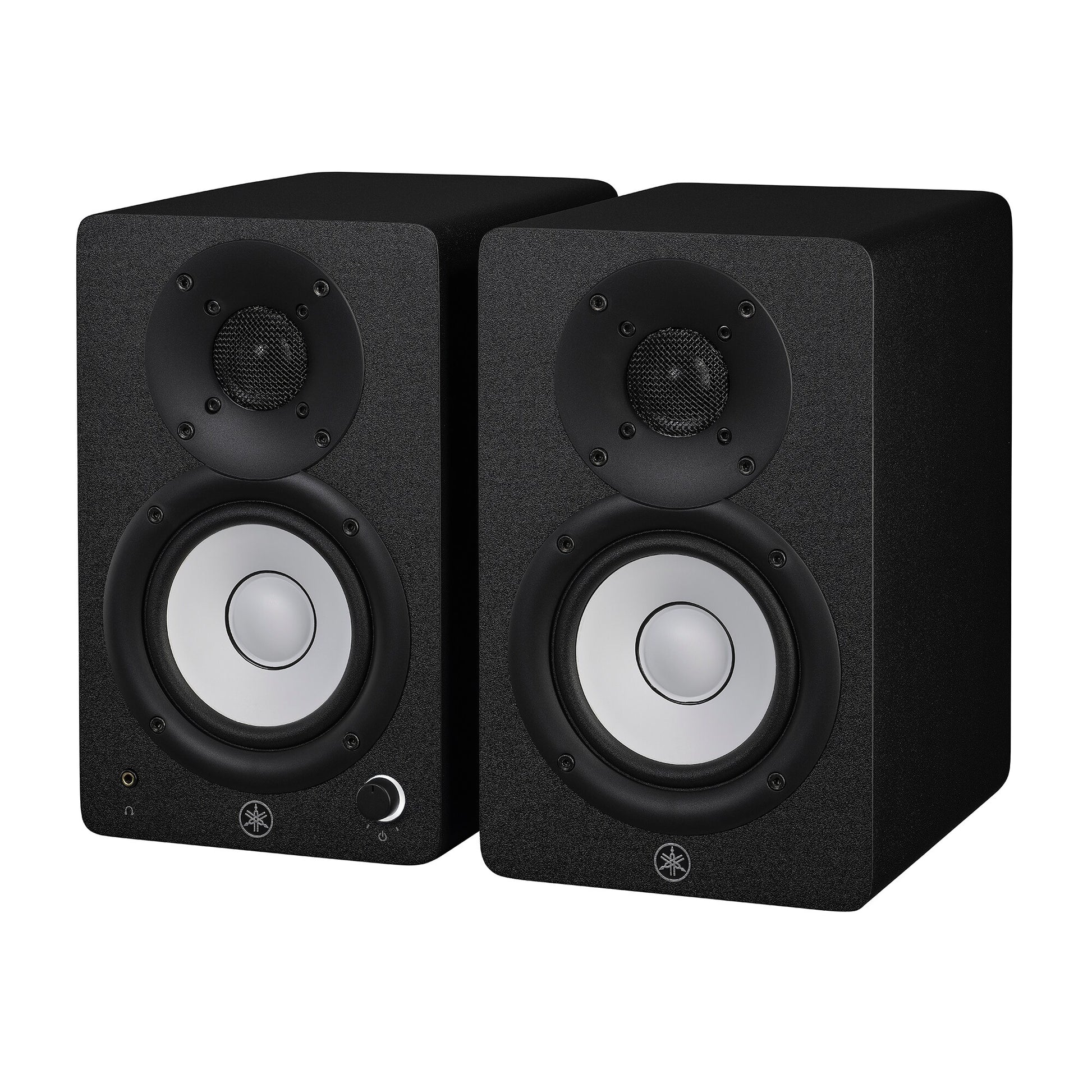 Yamaha HS4 powered studio monitors in black, angled pair view showing the left speaker's front volume knob and headphone jack