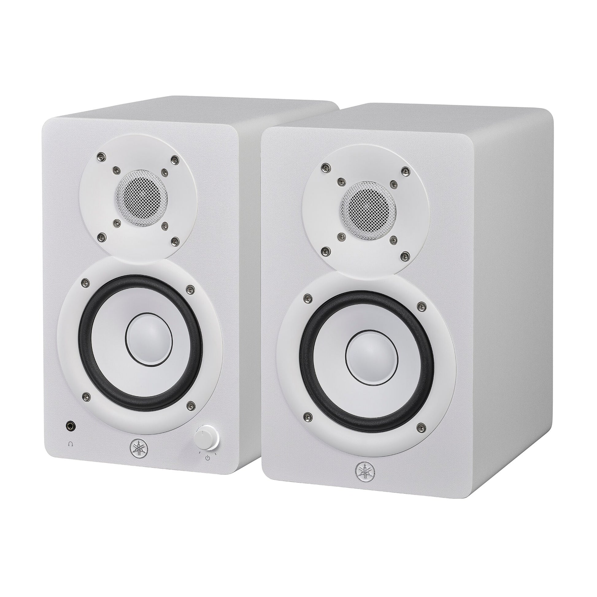 Yamaha HS4 powered studio monitors in white, angled pair view showing the left speaker's front volume knob and headphone jack