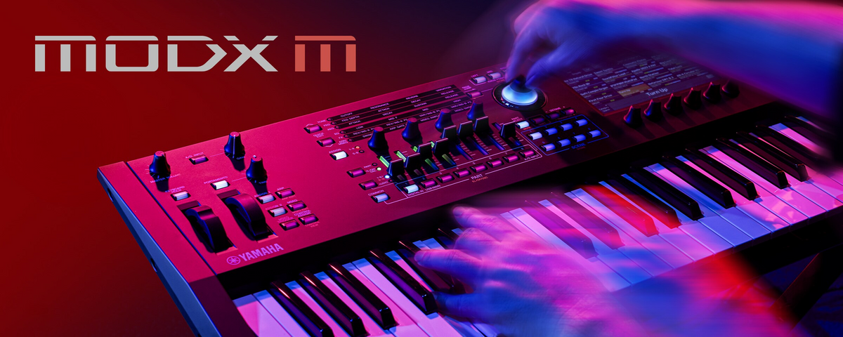 Yamaha MODX M synthesizer performed under red, purple and blue stage lighting