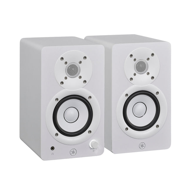 Yamaha HS3 powered studio monitors in white, angled pair view, with the left speaker's front volume knob and headphone jack