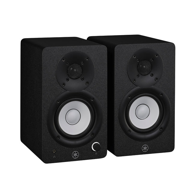 Yamaha HS3 powered studio monitors in black, angled pair view, with white cones and the left speaker's front volume knob and headphone jack