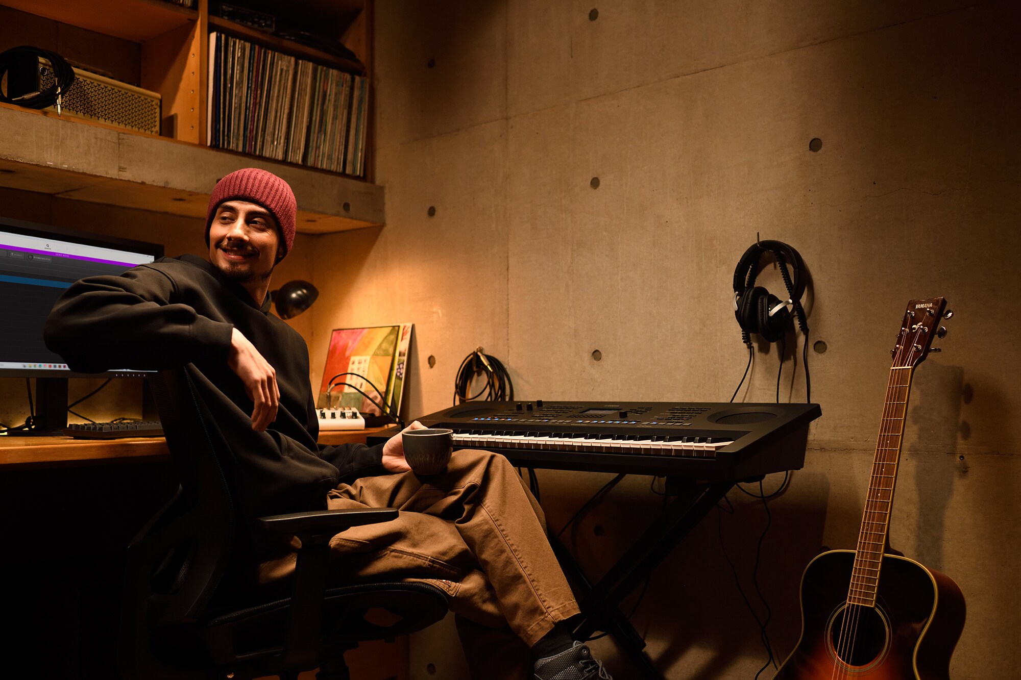 Keyboardist creating music with the Yamaha PSR-SX620 in a home studio