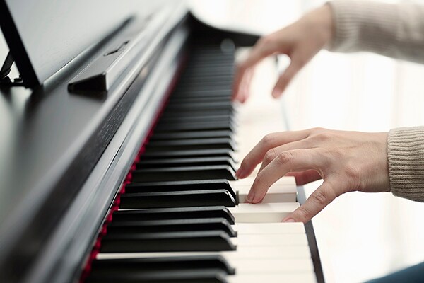 Playing the GrandTouch-E keyboard of a Yamaha Arius digital piano