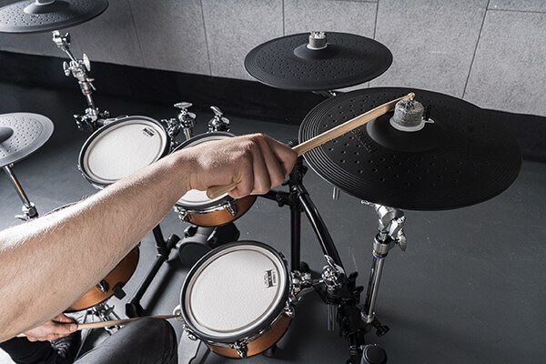 Drummer playing the three-zone cymbal pads on a Yamaha DTX8 electronic drum kit