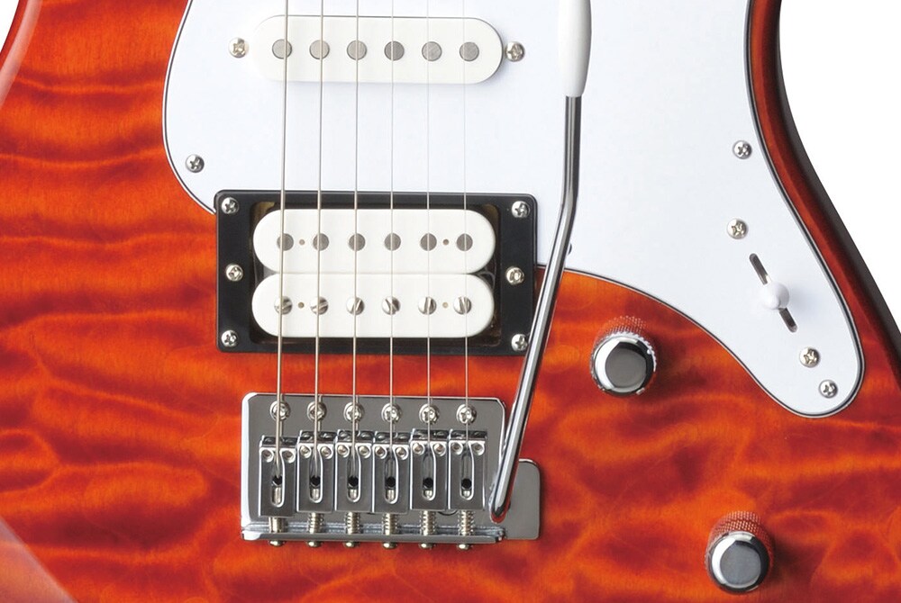 Close-up of the vintage-style tremolo with block saddles on a quilted maple Yamaha Pacifica 212 series guitar